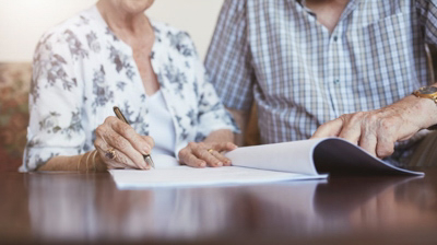 elder people signing a document